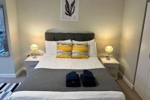 a bedroom with a large bed with two night stands at Beautiful Roomy Studio Central Manchester Sleeps 2 in Manchester