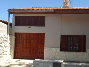 a house with two red doors and two windows at Descanso in San Rafael
