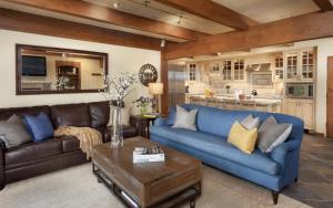 a living room with a blue couch and a kitchen at Timberline Condominiums 2 Bedroom Premier Unit C1D in Snowmass Village