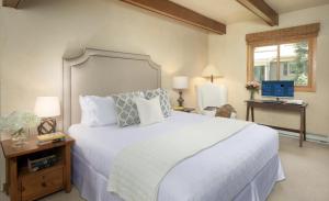 a bedroom with a large white bed and a desk at Timberline Condominiums 2 Bedroom Premier Unit C1D in Snowmass Village +24 photos