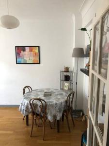 a dining room with a table and chairs at Next to Paris Metro - Calm & Convenient Apartment in Villejuif