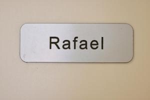 a white sign with the word raadi on a wall at Apartment R A M L J A K - Apartman "Rafael" in Vodice