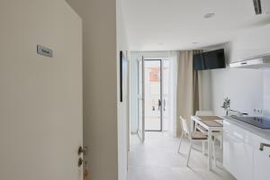 a kitchen and dining room with a table and chairs at Apartment R A M L J A K - Apartman "Rafael" in Vodice