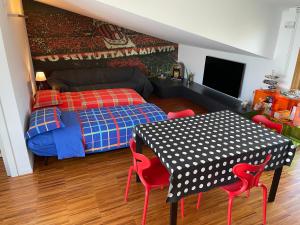 1 dormitorio con 1 cama y 1 mesa con sillas rojas en SANTA LUCIA HOME, en Vasto