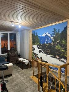 a living room with a large mural of a mountain at Sweetnight in Mestia
