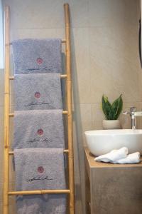 a towel ladder in a bathroom next to a sink at Villa Kallisti - private villa with hot tub, large garden, close to the beach in Ayía Varvára +23 photos