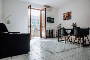 a living room with a table and chairs at Three-Square house {apartment} in Gioiosa Marea