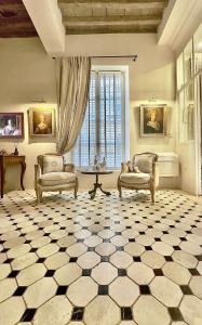 a large living room with two chairs and a table at Les Anges Deluxe Avignon in Avignon