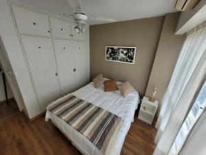 a bedroom with a bed and white cabinets at Pampa, Mayo home in Buenos Aires