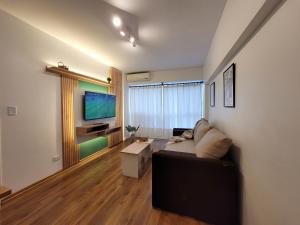 a living room with a couch and a flat screen tv at Pampa, Mayo home in Buenos Aires