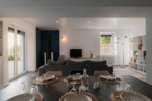a living room with two sinks in front of a couch at Gîte Sous le Verger in Songeson