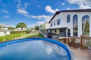 a swimming pool in front of a house at Moon Beach Manor with Private Pool and Hot Tub! in Cocoa Beach