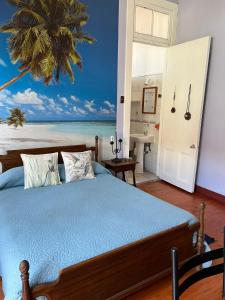 a bedroom with a bed with a view of the ocean at El Mirador De Valparaiso in Valparaíso