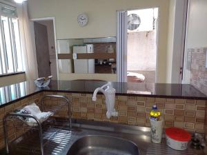 a kitchen with a sink and a counter top at Apartamento Mobiliado temporada in Aracaju