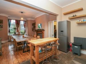 a kitchen and dining room with a table and a refrigerator at Sunnycote in Carnforth