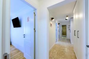 a hallway with white walls and a white door at Five Stars Apartment in Timişoara