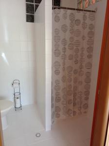 a bathroom with a shower with a shower curtain at Penzión Skitour in Stará Lesná