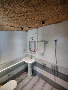 a bathroom with a sink and a shower at Circle Square in Kasol
