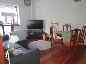 a living room with a couch and a table with a tv at Apartamento en la costa in Lekeitio