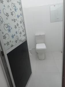 a bathroom with a toilet and a shower curtain at VILLA AAA WELIGAMA in Weligama