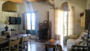 a living room with a table and a couch at Casa De Campo El Corral in Carmen de Areco