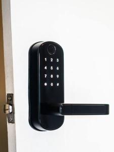 a black door handle on a white door at Beachfront Apartment near Bocas Town in Istmito