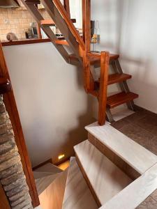 a wooden staircase in a room with a stair case at VS Villa Killini in Káto Panayía