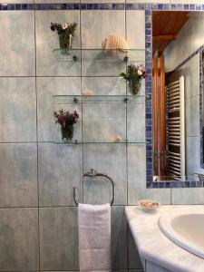 a bathroom with a sink and a shower with flowers at VS Villa Killini in Káto Panayía