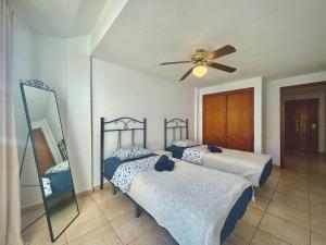 una camera con 2 letti e un ventilatore a soffitto di CASA VARGAS-TENERIFE a Los Cristianos