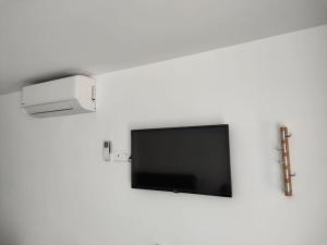 a flat screen tv hanging on a white wall at Studio Bleu in Obernai
