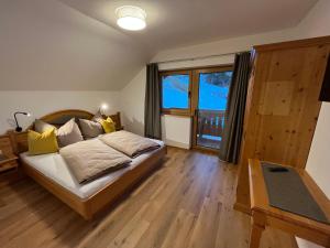 a bedroom with a bed and a large window at Haus Tennstein in Schladming