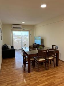 a living room with a dining room table and chairs at Departamento temporal zona Bv Galvez con chochera in Santa Fe +20 photos