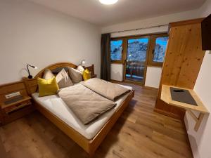 a bedroom with a large bed with yellow pillows at Haus Tennstein in Schladming