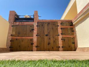 a pair of wooden doors on the side of a building at Ático duplex en Zahara de los Atunes in Zahara de los Atunes