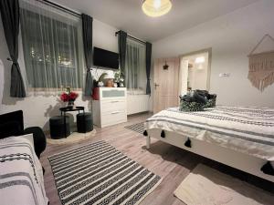 a bedroom with two beds and a dresser at Ladislaus Schnaps-Haus Falusi Vendégház in Csolnok +23 photos