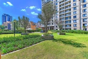 a park in front of a large building at Comfort Apartment SA in Johannesburg