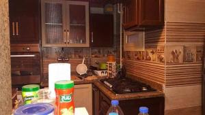 a kitchen with wooden cabinets and a counter top at شقه مفروش في التجمع الخامس in Cairo