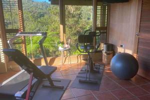 a room with a gym with a large window at Casa de Paz in Guayama