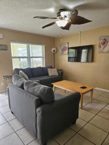 a living room with a couch and a table at Oasis Palms Resort in St. Pete Beach