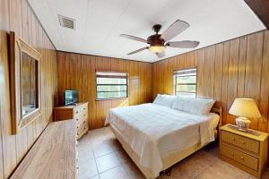 a bedroom with a bed and a ceiling fan at Fair Wind II in Tavernier