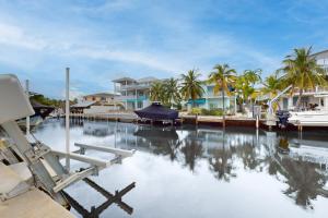 a marina with houses and a boat in the water at Fair Wind II in Tavernier