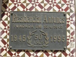 a blue and white sign on a brick wall at Residencial Antunes in Coimbra