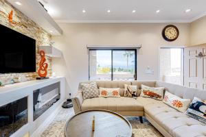 a living room with a couch and a tv at Desert Cottage in Fountain Hills