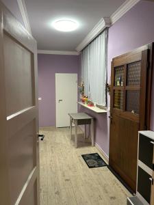 a room with purple walls and a table and a door at Gasthaus da Enzo in Siefersheim