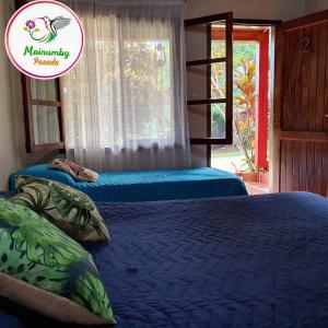 a bedroom with two beds and a sign that says mummy paradise at Mainumby- Colibri Posada in Puerto Iguazú