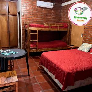 a room with two bunk beds in a brick wall at Mainumby- Colibri Posada in Puerto Iguazú