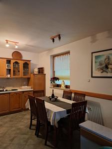 a kitchen with a table and chairs in a room at Apartma Smole in Kranjska Gora