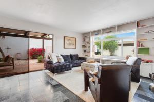 a living room filled with furniture and a large window at Hidden Bloom Sanctuary in Litchfield Park