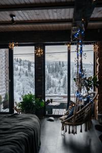 a bedroom with a view of a snowy mountain at Карпатське Hygge in Slavske