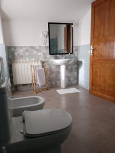 a bathroom with a toilet and a sink and a mirror at RossoToscano 